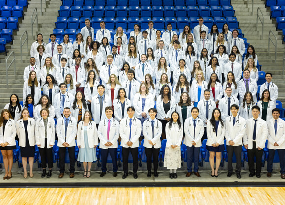 Group photo of students in their white coats